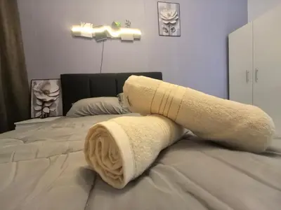 a rolled up towel on a bed in a bedroom at Ipoh Anderson Suite 1802 By Hopestay in Ipoh