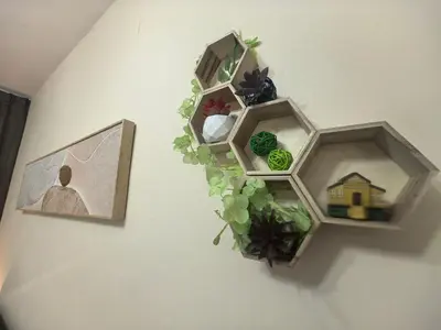a wall with two wooden shelves with plants and a picture at Ipoh Anderson Suite 1802 By Hopestay in Ipoh