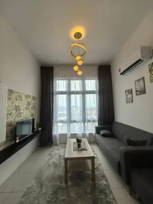 a living room with a couch and a table at Ipoh Anderson Suite 1802 By Hopestay in Ipoh