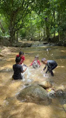 a group of people playing in a river at River Chalet Kemangi Valley Baling in Kampong Kemangi