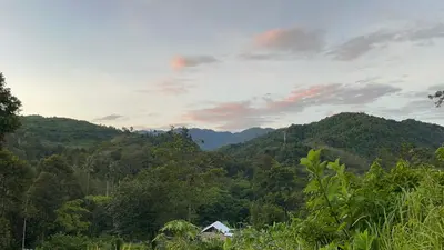 a view of a mountain with a house and trees at River Chalet Kemangi Valley Baling in Kampong Kemangi
