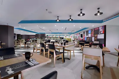 a restaurant with tables and chairs and a cafeteria at Neo+ Penang in George Town