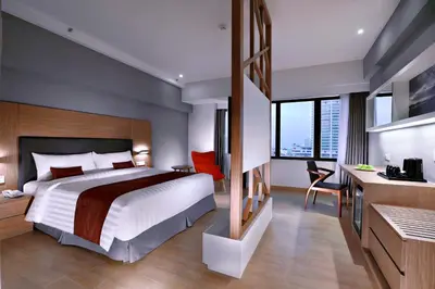 a hotel room with a large bed and a desk at Neo+ Penang in George Town