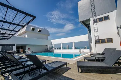 a swimming pool on the roof of a house at Neo+ Penang in George Town