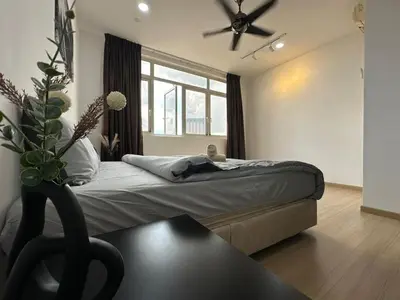 a bedroom with a bed with a ceiling fan at Netflix Studio Seaview 118Island Plaza in Tanjong Tokong