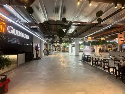 an empty hallway with tables and chairs in a building at Netflix Studio Seaview 118Island Plaza in Tanjong Tokong