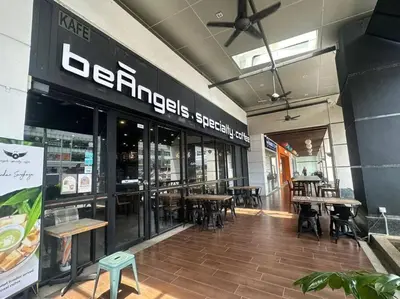 a restaurant with tables and chairs in a building at Netflix Studio Seaview 118Island Plaza in Tanjong Tokong