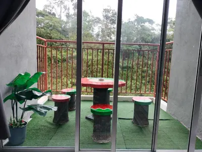 a patio with a table and stools on a balcony at Ammara Homestay 2 Emerald Avenue Brinchang in Brinchang