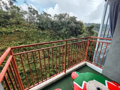 a balcony with a view of a forest at Ammara Homestay 2 Emerald Avenue Brinchang in Brinchang