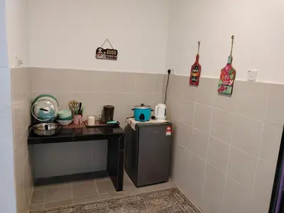 a kitchen with a counter and a small refrigerator at Ammara Homestay 2 Emerald Avenue Brinchang in Brinchang