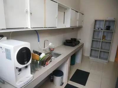 a kitchen with a sink and a microwave at Setia Homestay Chemor Setia in Chemor