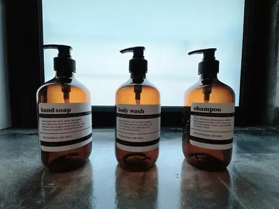 three bottles of liquid soap sitting on a table at The Jubilee Guest House in Ipoh