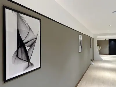 a hallway with paintings on the walls of a house at The Jubilee Guest House in Ipoh