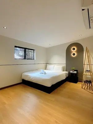 a bedroom with a bed and a ladder in it at The Jubilee Guest House in Ipoh