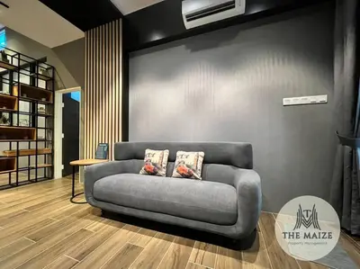 a couch sitting in a room with a wall at The Urban Lodge - Tasek Avenue Ipoh in Ipoh