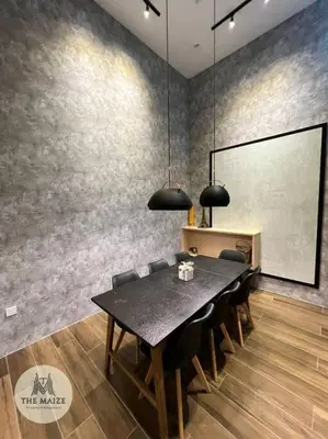 a dining room with a black table and chairs at The Urban Lodge - Tasek Avenue Ipoh in Ipoh