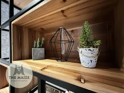 a shelf with two potted plants and a lantern at The Urban Lodge - Tasek Avenue Ipoh in Ipoh