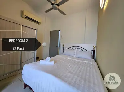 a bedroom with a white bed with a ceiling fan at Cozy Nest - Sky Garden Residence Ipoh in Chemor