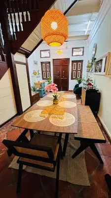 a large room with a table and a chandelier at The Bibik at 8 Clarke -NEW Entire #Unesco #HeritageHome in George Town