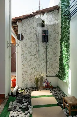a small garden with a shower in a house at The Bibik at 8 Clarke -NEW Entire #Unesco #HeritageHome in George Town