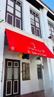 a red awning on the front of a building at The Bibik at 8 Clarke -NEW Entire #Unesco #HeritageHome in George Town