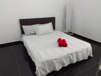 a pair of red shoes sitting on a bed at Islam Taqwa Homestay in Kuala Lipis