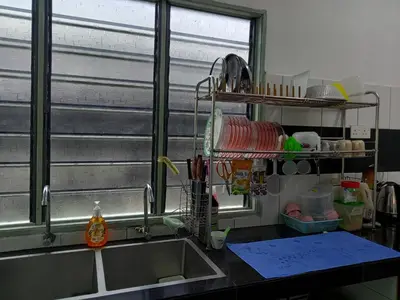 a kitchen counter with a sink and a window at Islam Taqwa Homestay in Kuala Lipis