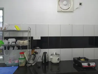 a kitchen with black and white tile on the wall at Islam Taqwa Homestay in Kuala Lipis