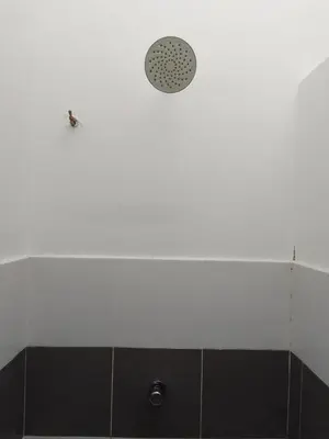 a shower with a shower head in a bathroom at Islam Taqwa Homestay in Kuala Lipis