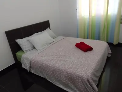 a red pillow sitting on top of a bed at Islam Taqwa Homestay in Kuala Lipis