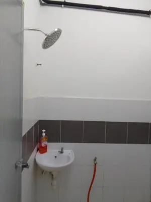 a bathroom with a sink and a shower at Islam Taqwa Homestay in Kuala Lipis