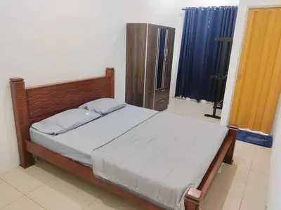 a bedroom with a bed with a wooden head board at Mysa at Tambun Ipoh in Kampong Batu Lapan