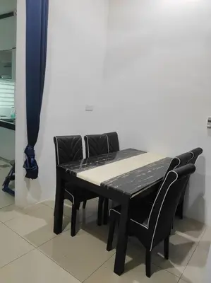 a black table with two black chairs sitting next to it at Mysa at Tambun Ipoh in Kampong Batu Lapan