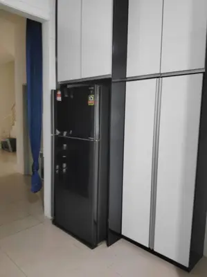 a black refrigerator in a room with white cabinets at Mysa at Tambun Ipoh in Kampong Batu Lapan