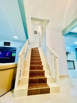 a staircase in a building with a stair case at Khalifah Homestay Penaga in Penaga