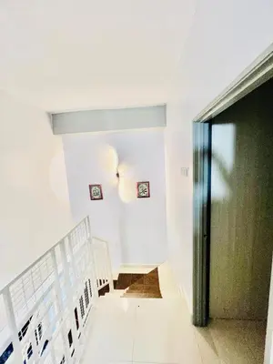 a hallway with a door and a stair case at Khalifah Homestay Penaga in Penaga
