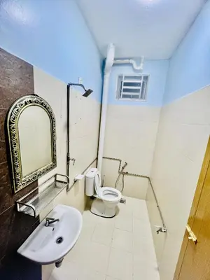 a bathroom with a sink and a toilet and a mirror at Khalifah Homestay Penaga in Penaga