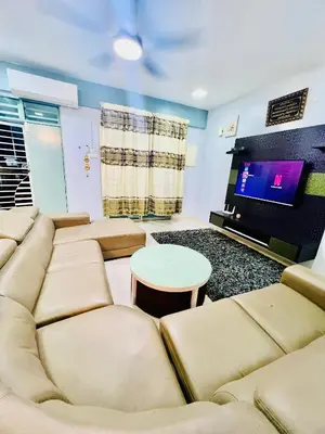 a living room with a couch and a tv at Khalifah Homestay Penaga in Penaga