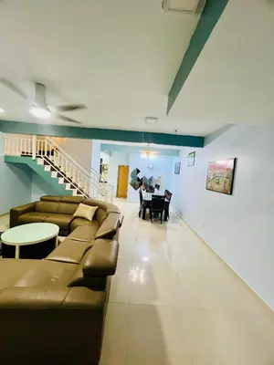 a living room with couches and a table and a dining room at Khalifah Homestay Penaga in Penaga