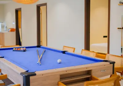a pool table with scissors and a ball on it at Ipoh Tiga Pool Villa by Papahost in Ipoh