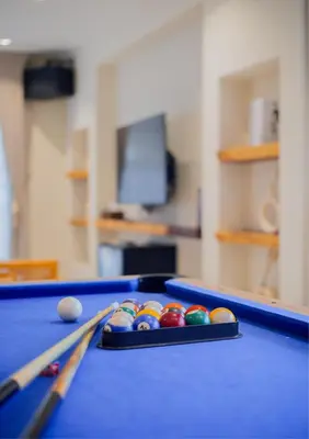 a pool table with balls on top of it at Ipoh Tiga Pool Villa by Papahost in Ipoh