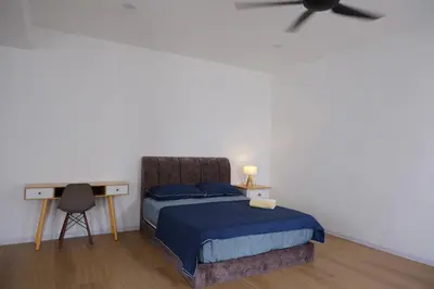 a bedroom with a bed and a desk at Homestay Bukit Mertajam - DHome in Bukit Mertajam