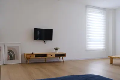 a living room with a tv on a white wall at Homestay Bukit Mertajam - DHome in Bukit Mertajam