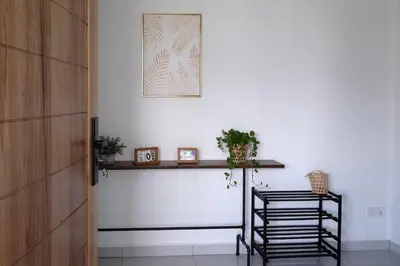 a room with a table and a picture on the wall at Homestay Bukit Mertajam - DHome in Bukit Mertajam