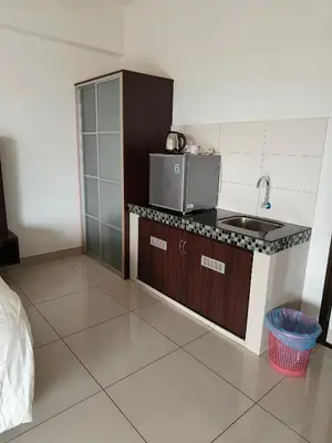a small kitchen with a sink and a counter at Marina Heights Apartment in Lumut