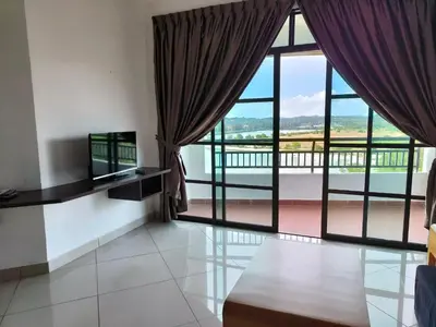 a living room with a large window with curtains at Marina Heights Apartment in Lumut