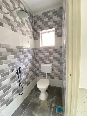 a bathroom with a toilet and a window at Rumah Bukit Jalan Kolam Air in Kuala Kubu Baharu