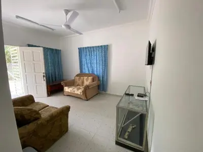 a living room with a couch and a chair at Rumah Bukit Jalan Kolam Air in Kuala Kubu Baharu