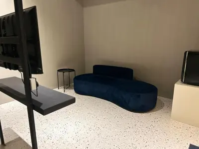 a room with a blue bean bag chair and a television at M2 Living Townhouse in Ipoh in Ipoh