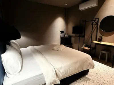a bedroom with a white bed in a room at M2 Living Townhouse in Ipoh in Ipoh